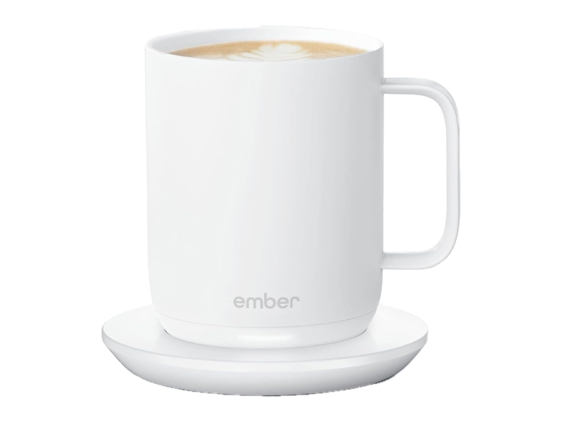 A white Ember Mug 2 shown with coffee on its white charging coaster